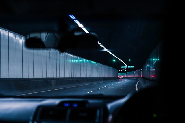 electric car driving in a tunnel at night